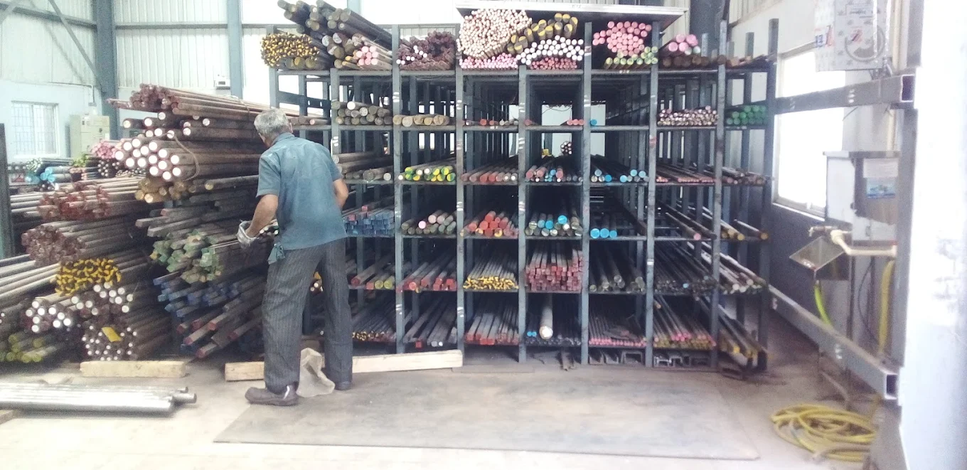 Worker organizing steel bars on storage racks